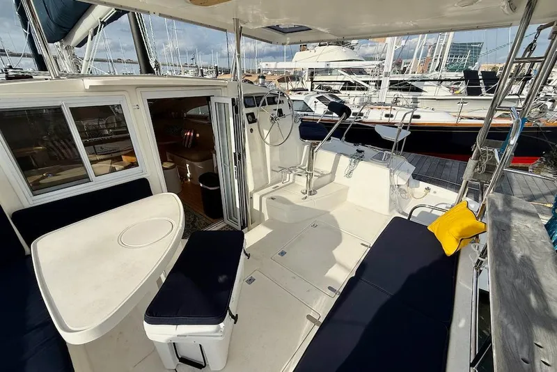Slide: The Image of 2006 Island Spirit 401 yacht interior with seating, table, and helm station in marina. - 5