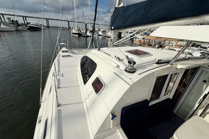 Slide: The Image of Sailboat Island Spirit 401, 2006 model, docked in a marina with bridge in background. - 9