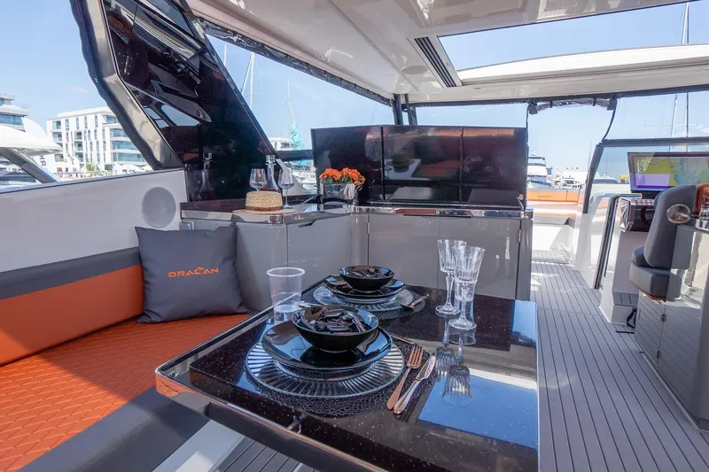 Slide: The Image of Luxurious interior of 2026 Dracan 42 Catamaran with elegant dining setup and modern amenities. - 16