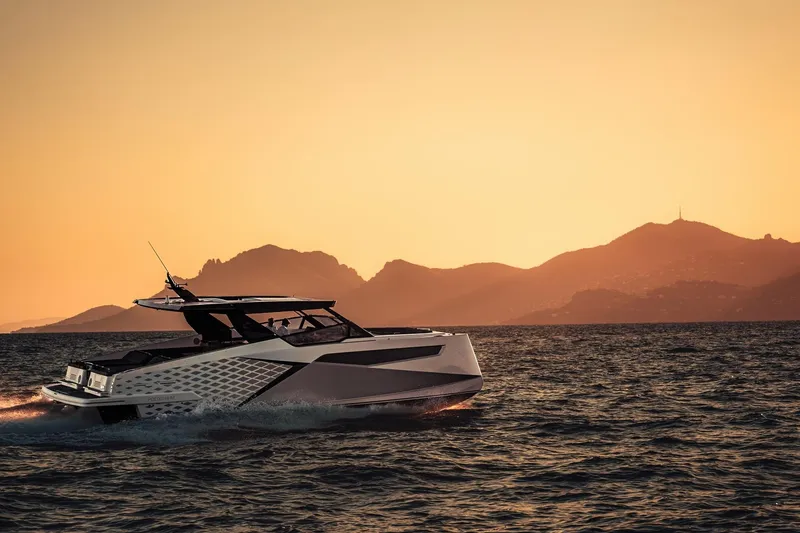 Slide: The Image of 2026 Dracan 42 Catamaran cruising at sunset with mountainous backdrop. - 3
