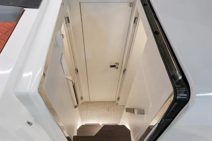 Slide: The Image of Interior view of 2026 Dracan 42 Catamaran, featuring sleek white stairway and modern design. - 31