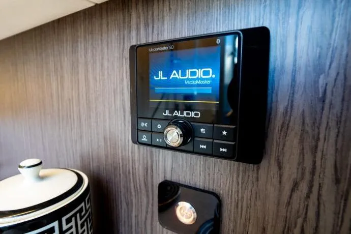Slide: The Image of JL Audio MediaMaster on Dracan 42 Catamaran, 2026 model, with sleek wood paneling. - 32