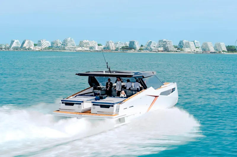 Slide: The Image of 2026 Dracan 42 Catamaran cruising on blue waters near modern coastal architecture. - 5