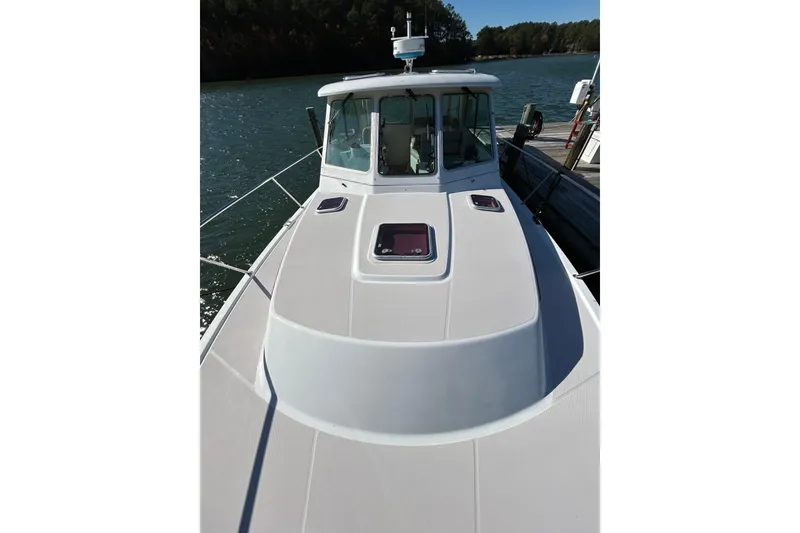 Slide: The Image of 2008 Back Cove 33 boat interior with sink, countertop, and wooden cabinetry. - 11