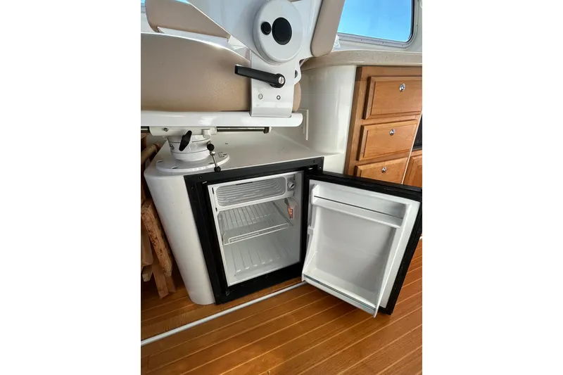Slide: The Image of Helm of 2008 Back Cove 33 boat with leather seat and navigation controls. - 16