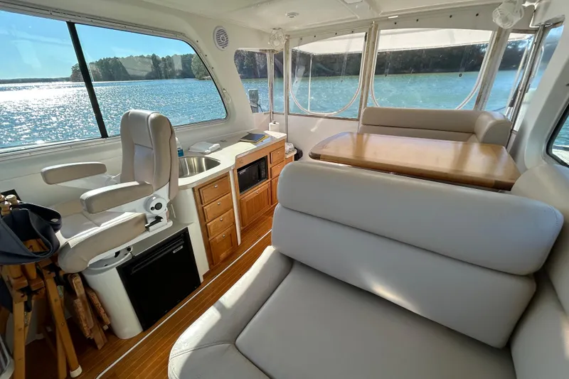 Slide: The Image of 2008 Back Cove 33 yacht interior with kitchenette, featuring sink and stove, overlooking water. - 17