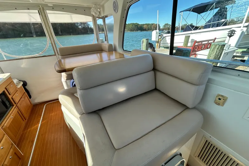 Slide: The Image of 2008 Back Cove 33 interior with polished wooden flooring and cabinetry. - 22