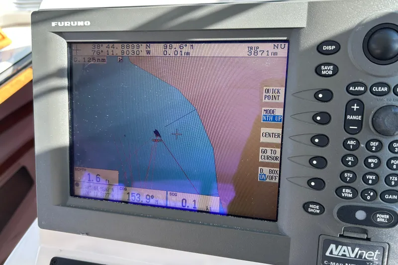 Slide: The Image of Control panel of a 2008 Back Cove 33 boat with throttle and side power controls. - 28