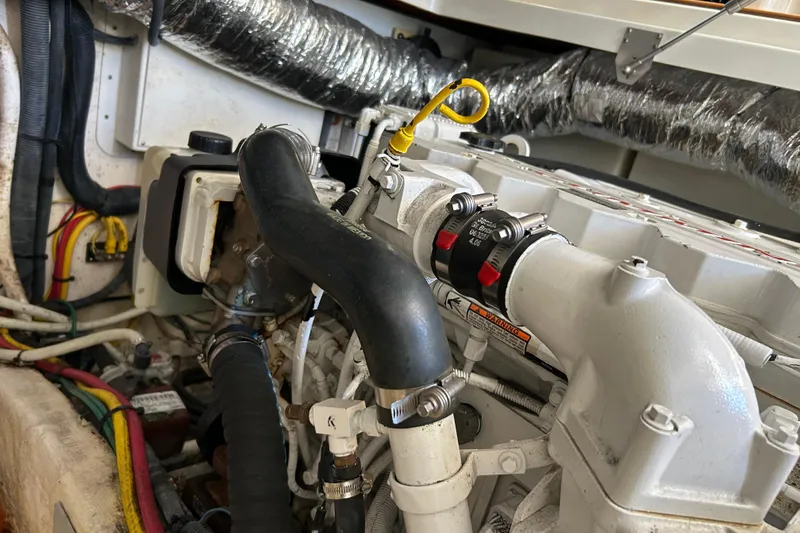 Slide: The Image of 2008 Back Cove 33 boat interior with red toolbox, yellow cables, and white bucket. - 34