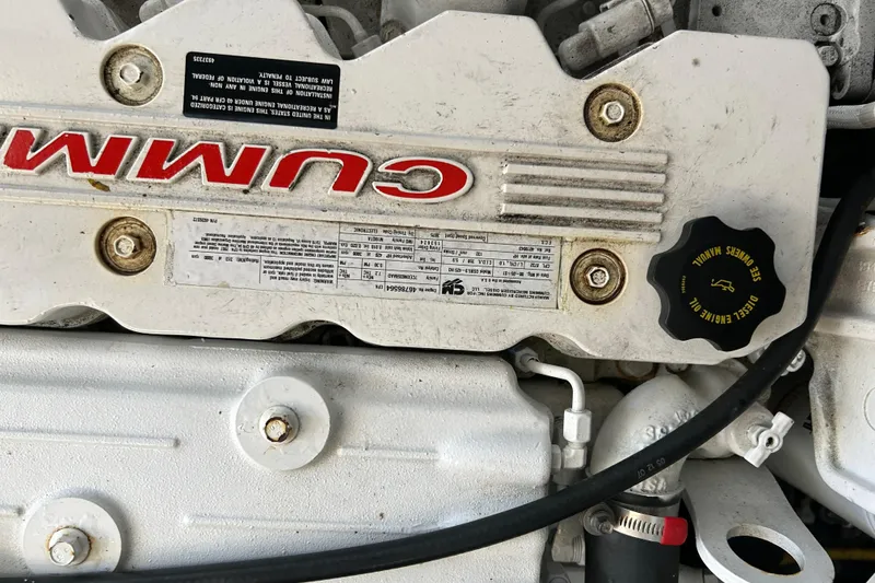 Slide: The Image of Engine compartment of a 2008 Back Cove 33 boat, showing hoses and components. - 36