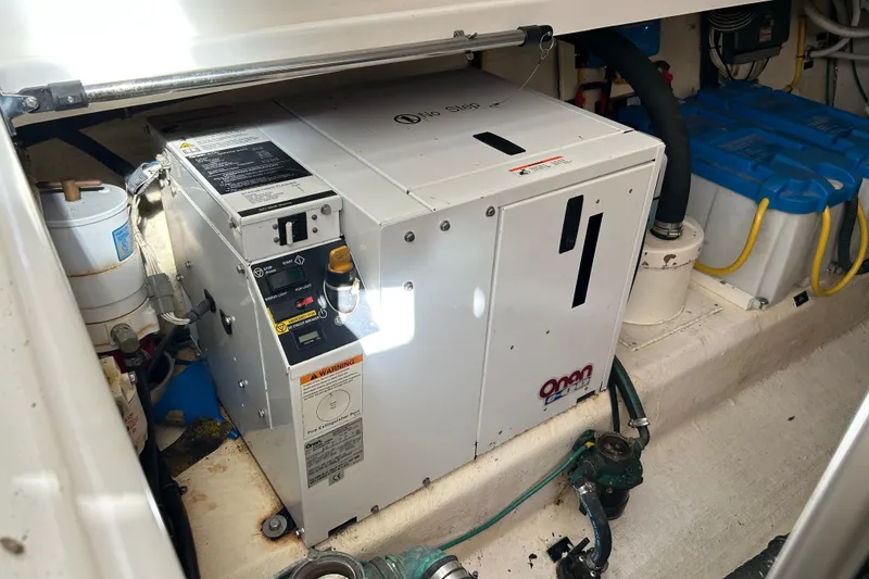 Slide: The Image of Engine compartment of a 2008 Back Cove 33 boat, showing wiring and mechanical components. - 37