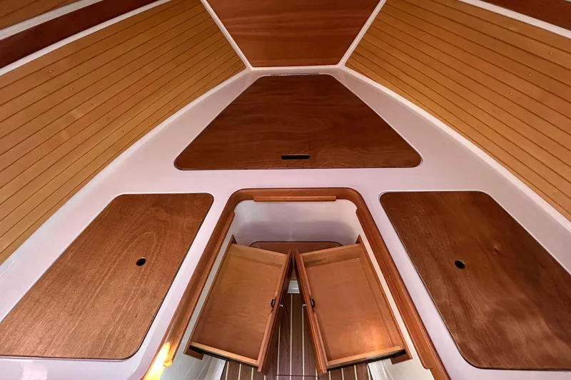 Slide: The Image of 2008 Back Cove 33 interior with wooden cabinetry, seating, and control panel. - 42