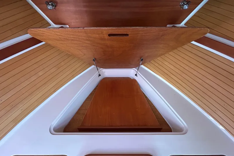 Slide: The Image of 2008 Back Cove 33 interior with wooden cabinetry and storage compartments. - 43