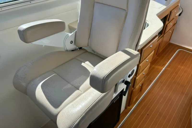 Slide: The Image of 2008 Back Cove 33 boat deck with wood finish and seating area. - 8