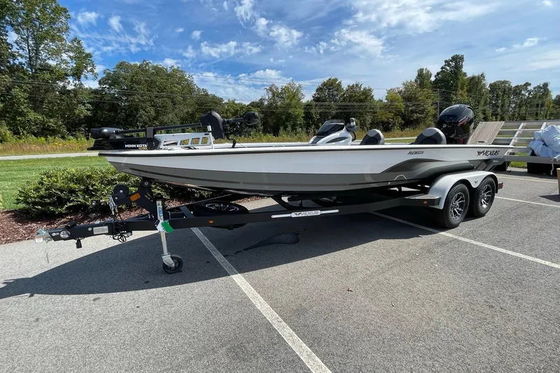 Slide: The Image of 2025 Vexus AVX1980 boat on trailer, parked outdoors under a clear blue sky. - 3