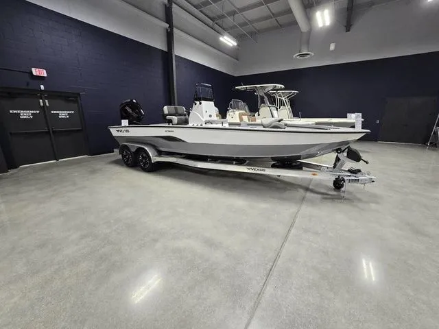 The Image of 2025 Vexus ACX2210 boat on trailer in showroom with polished concrete floor. - 1