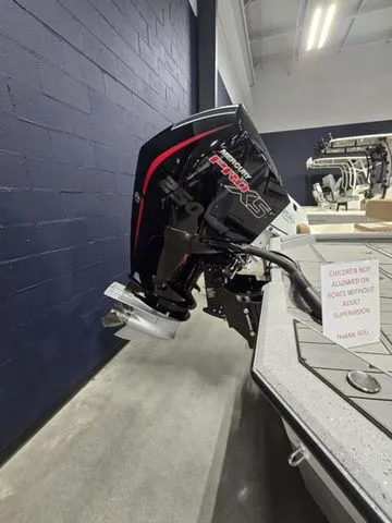 Slide: The Image of 2025 Vexus ACX2210 boat with powerful outboard motor in showroom setting. - 3