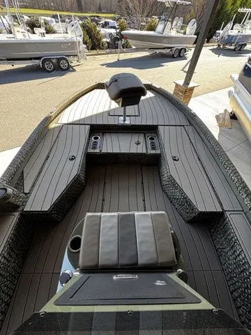 Slide: The Image of 2025 Vexus ACX2150 boat interior with sleek seating and modern design at a marina. - 7