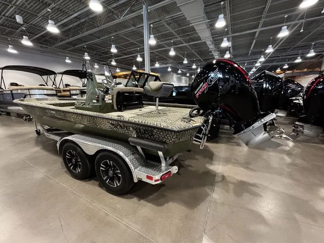 Slide: The Image of 2025 Vexus ACX2000 boat on trailer in showroom, featuring powerful outboard motor. - 3