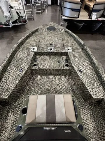 Slide: The Image of 2025 Vexus ACX2000 boat with camouflage pattern, displayed indoors. - 7
