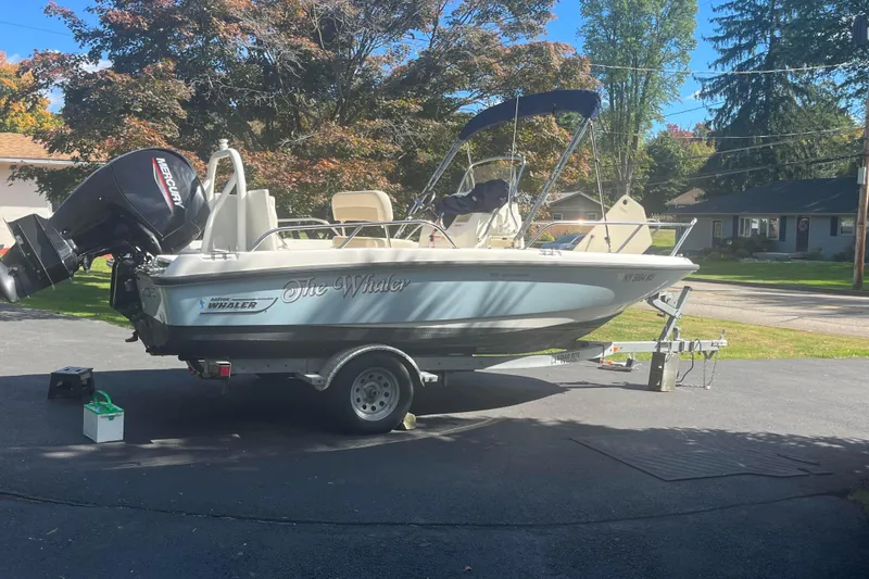 Slide: The Image of 2021 Boston Whaler 180 Dauntless boat on trailer, parked in driveway. - 3