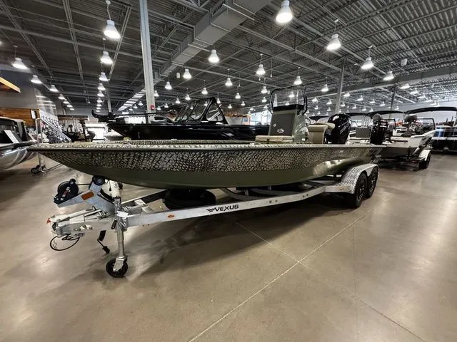 Slide: The Image of 2025 Vexus ACX2000 boat on display in a showroom with modern lighting. - 2