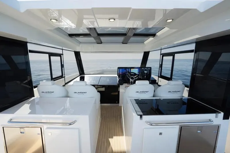 Slide: The Image of Interior view of 2026 De Antonio Yachts D50, featuring modern helm and seating. - 13
