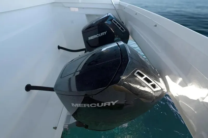 Slide: The Image of Twin Mercury outboard engines on a 2026 De Antonio Yachts D50, glistening in sunlight. - 18