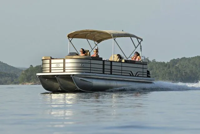 The Image of 2025 Veranda VR22RC Tri-Toon cruising on a serene lake with passengers enjoying the ride. - 1