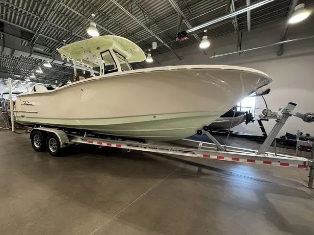 The Image of 2025 Pioneer Pelagic 270 boat on trailer in indoor showroom. - 1