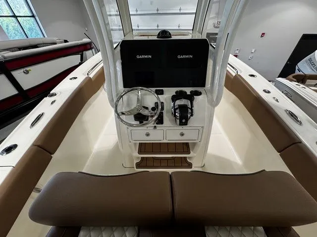 Slide: The Image of 2025 Pioneer Pelagic 270 boat interior with dual Garmin displays and brown seating. - 4