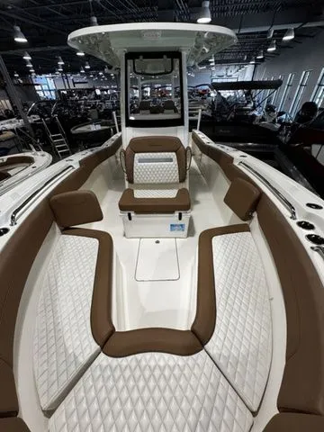 Slide: The Image of 2025 Pioneer Pelagic 270 boat interior with brown and white cushioned seating. - 8