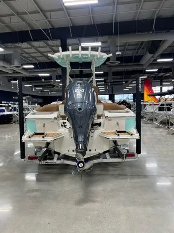 Slide: The Image of 2025 Pioneer Islander 222 boat with powerful outboard motor in showroom. - 2