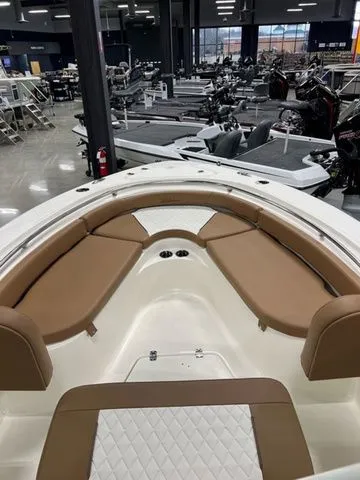 Slide: The Image of 2025 Pioneer Islander 222 boat interior with tan seating in a showroom. - 5