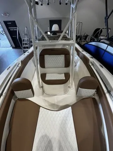 Slide: The Image of 2025 Pioneer ISLANDER 202 boat interior with brown and white seating. - 8