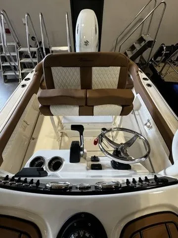 Slide: The Image of 2025 Pioneer ISLANDER 202 boat interior with steering wheel and seating. - 10