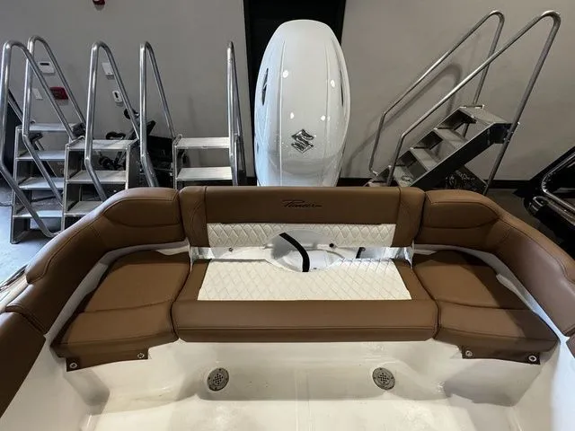 Slide: The Image of 2025 Pioneer ISLANDER 202 boat interior with brown seating and Suzuki outboard motor. - 13