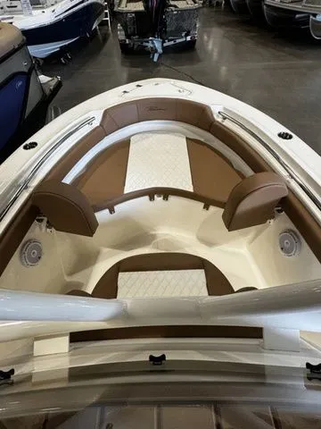 Slide: The Image of 2025 Pioneer ISLANDER 202 boat interior with brown and white seating in showroom. - 7