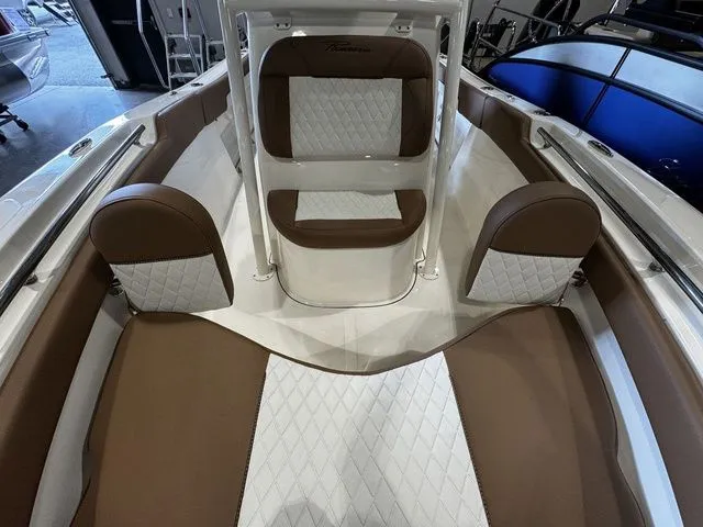 Slide: The Image of 2025 Pioneer ISLANDER 202 boat interior with brown and white cushioned seating. - 9