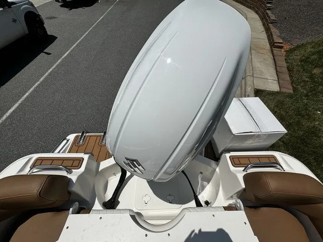 Slide: The Image of 2025 Pioneer ISLANDER 202 boat with white outboard motor and brown seating. - 13