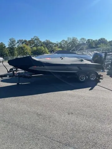 Slide: The Image of 2025 Ikon Boats VLX21 on trailer, parked outdoors under clear blue sky. - 2