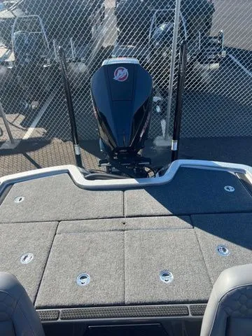 Slide: The Image of 2025 Ikon Boats VLX21 with outboard motor, viewed from the deck, near a chain-link fence. - 3