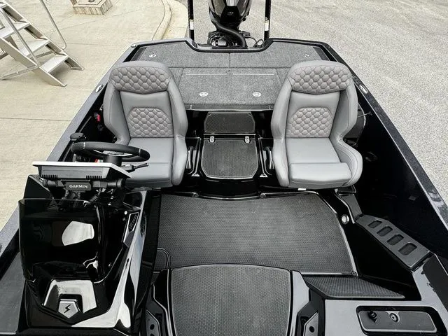 Slide: The Image of 2025 Ikon Boats VLX21 interior with dual gray seats and modern dashboard. - 12