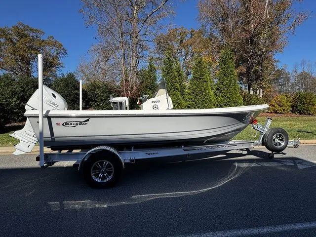 The Image of 2025 Bulls Bay 2000 boat on trailer, parked on road with trees in background. - 1