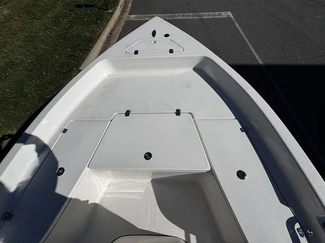 Slide: The Image of 2025 Bulls Bay 2000 boat deck, white finish, parked on pavement. - 6