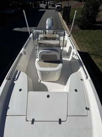 Slide: The Image of 2025 Bulls Bay 2000 boat with center console and seating, parked on a street. - 7