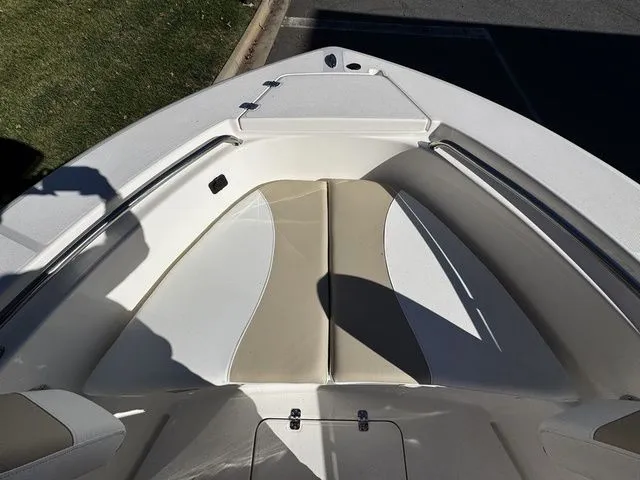 Slide: The Image of 2025 Bulls Bay 200CC boat interior with beige and white seating, viewed from above. - 8