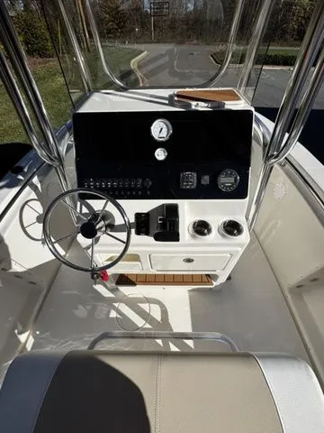 Slide: The Image of 2025 Bulls Bay 200CC boat console with steering wheel and gauges. - 6