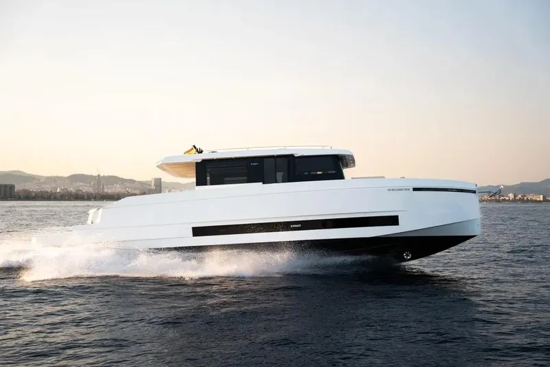 Slide: The Image of 2026 De Antonio Yachts D60 cruising on open water at sunset. - 15