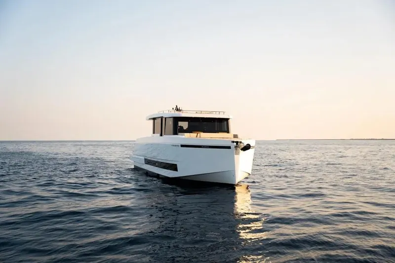 Slide: The Image of 2026 De Antonio Yachts D60 cruising on calm sea at sunset. - 20